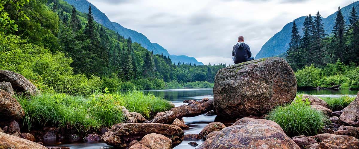 a man stares out at a lake as he thinks about viewpoint dual recovery center