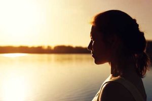 a woman looks out on the water and thinks about viewpoint dual recovery center in arizona