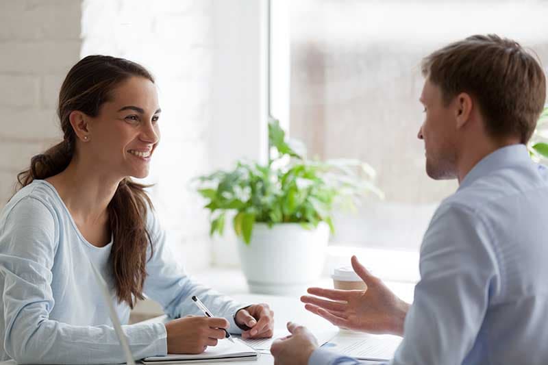 a man talks to a woman about attending an outpatient treatment program at viewpoint dual recovery center