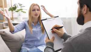 a woman talks to a therapist at a mental health treatment center