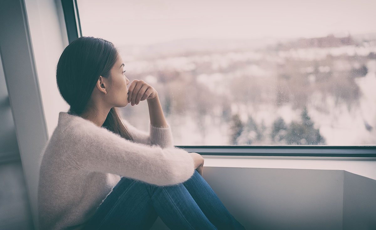 a woman stares out the window and wonders if she has depression and anxiety