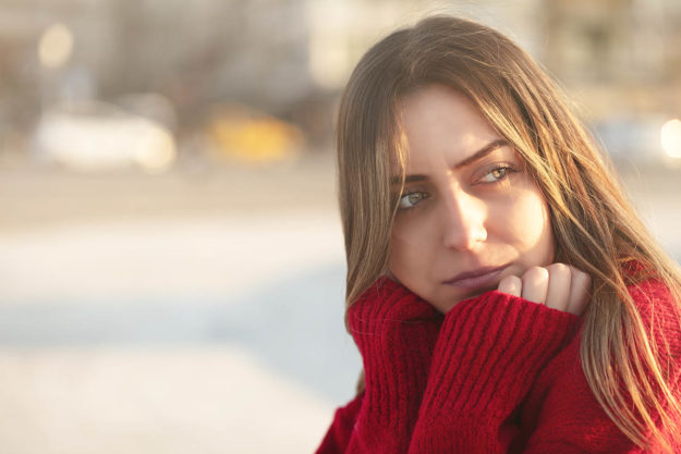 a woman rests her chin on her hands as she considers polysubstance abuse