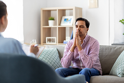 a man talking to a doctor about opioid addiction treatment program for his friend