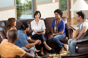 a group therapy session talking about process addiction treatment program
