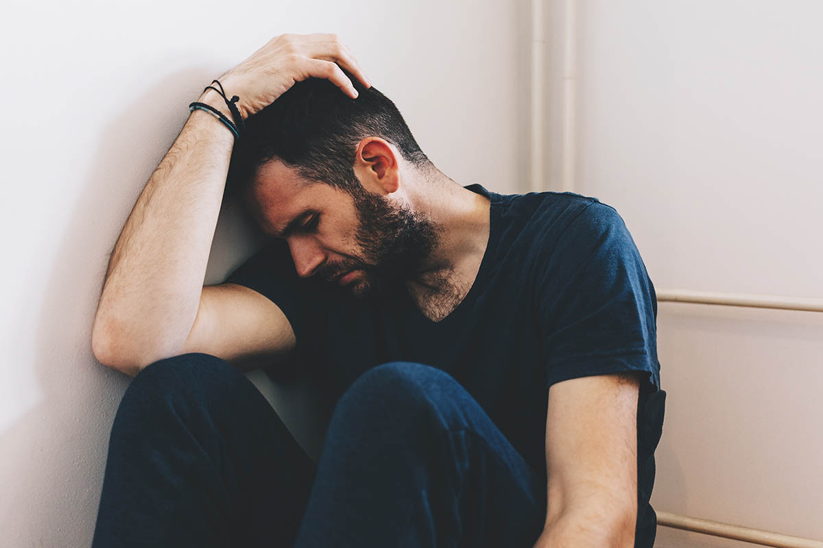 a man feeling distressed while thinking about common mental health disorders