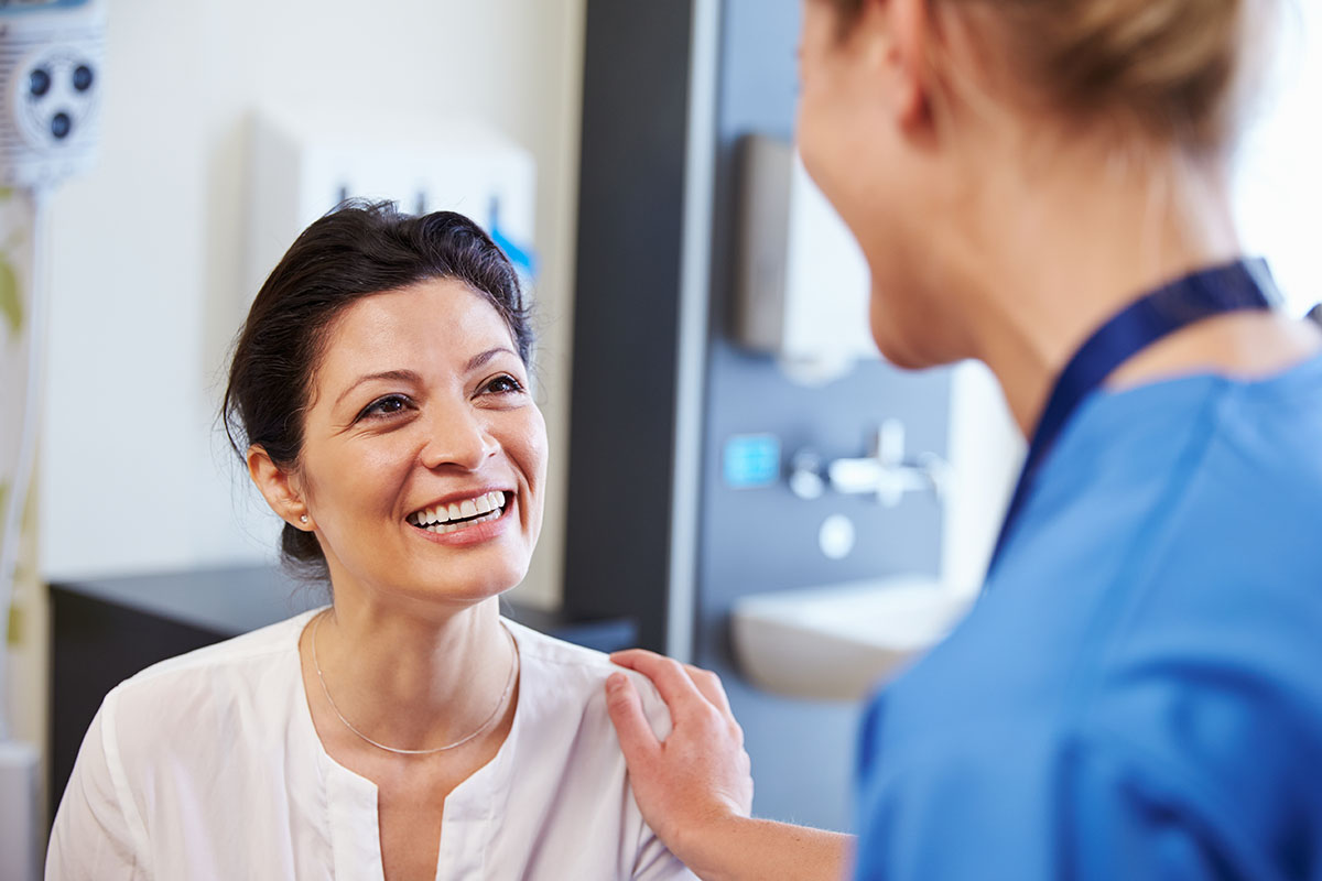 a doctor talking to their patient about benefits of a mat program