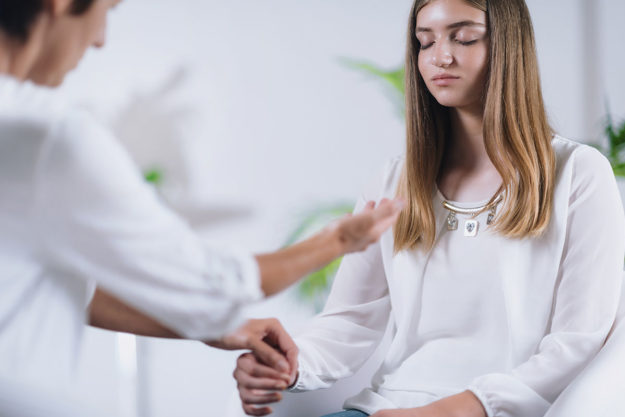 a woman talking to her doctor about holistic treatment options